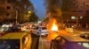 FILE - A police motorcycle burns during a protest over the death of Mahsa Amini, a woman who died after being arrested by the Islamic republic's "morality police", in Tehran, Iran Sept. 19, 2022.