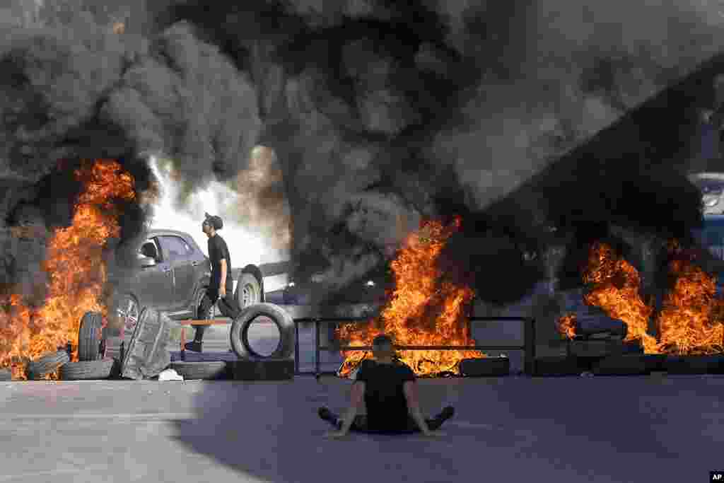 Tires set fire by Palestinians burn at the site where two Palestinians were shot and killed by the Israeli army in the Jalazone refugee camp near the city of Ramallah, West Bank.