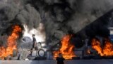 Tires set fire by Palestinians burn at the site where two Palestinians were shot and killed by the Israeli army in the Jalazone refugee camp near the city of Ramallah, West Bank.
