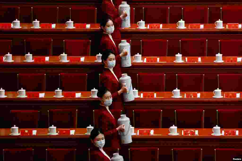 Attendants serve tea for delegates before the opening ceremony of the 20th National Congress of the Communist Party of China, at the Great Hall of the People in Beijing, China.