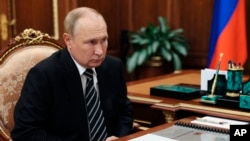 ប្រធានាធិបតី​រុស្ស៊ី លោក Vladimir Putin កំពុងស្ដាប់​លោក Stanislav Voskresensky អភិបាលតំបន់ Ivanovo និយាយ នៅ​វិមាន​ក្រឹមឡាំង ក្នុង​រដ្ឋធានី​មូស្គូ ប្រទេស​រុស្ស៊ី ថ្ងៃទី ៤ ខែតុលា ឆ្នាំ២០២២។ (Kremlin Pool Photo via AP)