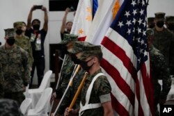 FILE - U.S. Marines watch during the entry of colors as part of the opening ceremonies of an annual joint military exercise called Kamandag, the Tagalog acronym for "Cooperation of the Warriors of the Sea," at Fort Bonifacio, Taguig City, Philippines, Oct. 3, 2022.