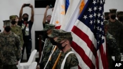 Marines watch during the entry of colors as part of the opening ceremonies of an annual joint military exercise called Kamandag the Tagalog acronym for "Cooperation of the Warriors of the Sea" at Fort Bonifacio, Taguig City, Philippines, on Oct. 3, 2022.