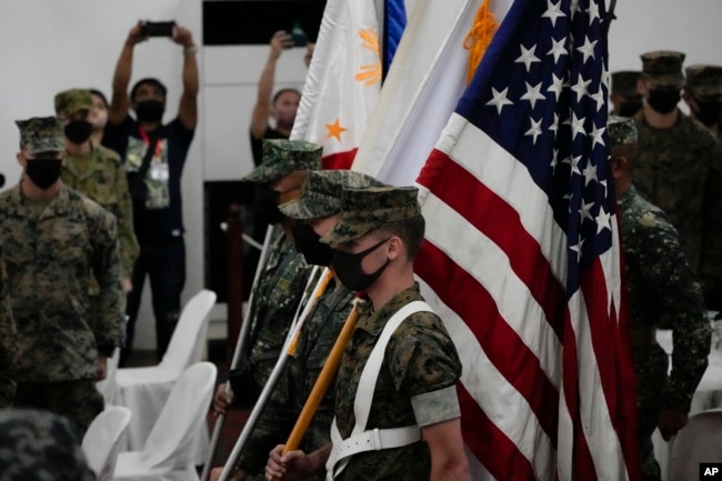 FILE - U.S. Marines watch during the entry of colors as part of the opening ceremonies of an annual joint military exercise called Kamandag, the Tagalog acronym for