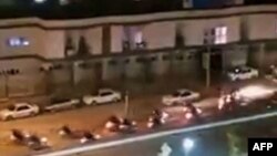 This image grab from a UGC video posted Oct. 28, 2022, reportedly shows Iranian security forces on motorbikes in front of the dormitories of the Kurdistan University Faculty of Medical Sciences in Sanandaj, the main city of Iran's Kurdistan province.