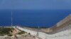 FILE - The wall on the Israeli border with Lebanon, is seen at right, with the Mediterranean Sea in the distance, Oct. 14, 2022. Israel's Supreme Court on Oct. 23, threw out four legal challenges to a landmark maritime agreement between Israel and Lebanon. 