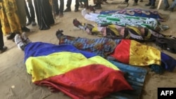 FILE: Bodies covered by Chadian flag are lined up on the ground during a protest in NDjamena, Chad, Oct. 20, 2022. 