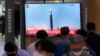 A TV screen shows a file image of a North Korea missile launch during a news program at the Seoul Railway Station in Seoul, South Korea, Sept. 28, 2022. 