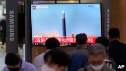 A TV screen shows a file image of a North Korea missile launch during a news program at the Seoul Railway Station in Seoul, South Korea, Sept. 28, 2022. 