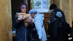 People receive bread at humanitarian aid center in Kramatorsk, Ukraine, Oct. 26, 2022.