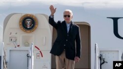 President Joe Biden waves as he boards Air Force One upon departure, Oct. 12, 2022, at Andrews Air Force Base, Md. Biden is en route to Colorado, California, Oregon, and returning to Delaware. 