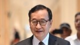 FILE - Cambodian opponent in exile and leader of the Cambodia National Rescue Party (CNRP) Sam Rainsy, speaks to the press as he arrives at the court house accused in a defamation lawsuit filed by Cambodia's prime minister, in Paris on September 1, 2022.