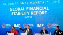 
Tobias Adrian, second from left, monetary and capital markets department director at the International Monetary Fund, speaks at a news conference during the 2022 annual meeting of the IMF and the World Bank Group, Oct. 11, 2022, in Washington. 