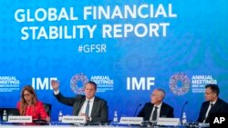 
Tobias Adrian, second from left, monetary and capital markets department director at the International Monetary Fund, speaks at a news conference during the 2022 annual meeting of the IMF and the World Bank Group, Oct. 11, 2022, in Washington. 