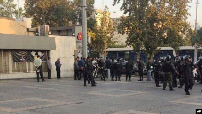 This photo taken by an individual not employed by the AP and obtained outside Iran shows police outside the Sharif University of Technology during a student protest at sparked by the death of Mahsa Amini in the custody of police, in Tehran, Oct. 7, 2022.