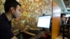 FILE - A customer uses a computer at an internet cafe in Tehran, May 9, 2011. An online coalition on Oct. 20, 2022, blasted Iran’s restrictions on internet access during nationwide protests over the death of Mahsa Amini the previous month. 