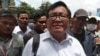 Son Chhay, center, deputy leader of the opposition political Candlelight Party, talks to the media in front of the Phnom Penh Municipal Court in Phnom Penh, Cambodia, Friday, Oct. 7, 2022.