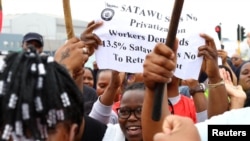 Transnet workers hold up a paper with employee demands amid nationwide strikes in Cape Town, South Africa, October 11, 2022. 