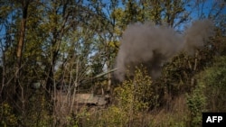 Ukrainian servicemen fire a Polish 155mm self-propelled tracked gun-howitzer Krab from a position on the front line in the Donetsk region, Oct. 19, 2022, amid Russia's invasion of Ukraine. 