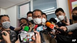 Chief executive of Uthai Sawan Sub-district Administrative Organization Danaichok Boonsom, talks to reporters at a police station in Uthai Sawan, north eastern Thailand, Oct. 9, 2022. 