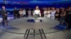 Journalists at Slovenia public broadcaster RTV gather during a live broadcast to show support for colleagues who had been reassigned after an anchor introduced a segment by saying it was being broadcast under the instruction of the chief news editor. (Screenshot TV Slovenia/RTV) 