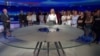 Journalists at Slovenia public broadcaster RTV gather during a live broadcast to show support for colleagues who had been reassigned after an anchor introduced a segment by saying it was being broadcast under the instruction of the chief news editor. (Screenshot TV Slovenia/RTV)