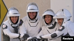 NASA's Crew 5 members pose for a picture while departing their crew quarters for launch aboard a SpaceX Falcon 9 rocket at the Kennedy Space Center in Cape Canaveral, Florida, Oct. 5, 2022.