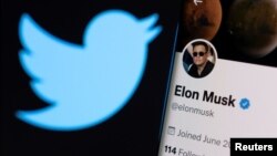 FILE - Elon Musk's twitter account is seen on a smartphone in front of the Twitter logo in this photo illustration taken, April 15, 2022. (REUTERS/Dado Ruvic/Illustration)