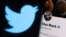 FILE - Elon Musk's twitter account is seen on a smartphone in front of the Twitter logo in this photo illustration taken, April 15, 2022. (REUTERS/Dado Ruvic/Illustration)