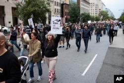 Protestors march through Washington, D.C., Saturday Oct. 1, 2022, during a rally calling for regime change in Iran following the death of Mahsa Amini, a young woman who died after being arrested in Tehran by Iran's notorious 'morality police.'