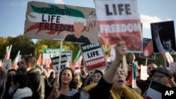 People attend a protest against the Iranian regime, in Berlin, Germany, Oct. 22, 2022, following the death of Mahsa Amini in the custody of the Islamic republic's notorious "morality police." 