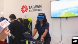An attendee rides a VR-equipped SOLE Fitness spin bike during the opening of the first-ever Taiwan Expo USA in Washington, D.C., on Oct. 13, 2022. (Photo: Business Wire via AP)