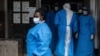 Medical staff members in protective gear are seen at Mubende Regional Referral Hospital, in Mubende, Uganda, Sept. 24, 2022.