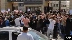 This grab taken from a UGC video posted online on October 1, 2022, shows Iranian students protesting outside a university in Tehran, against an ongoing crackdown on dissent over the death last month of Mahsa Amini in the custody of Iran's notorious morality police.