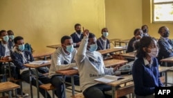 FILE - Students sit socially distanced in class as they attend a lesson at the Ethio Parents elementary and high school in Addis Ababa, Ethiopia, October 26, 2020.