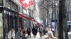 FILE - Shoppers walk along the Bahnhofstrasse shopping street in Zurich, Switzerland, March 1, 2021. 