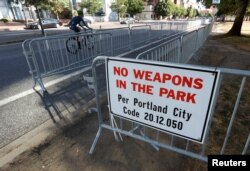 A "No Weapons" sign is seen at a park where the right-wing Patriot Prayer group planned to rally in Portland, Ore., Aug. 4, 2018.
