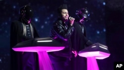 The Weeknd, center, and Daft Punk perform at the 59th annual Grammy Awards, Feb. 12, 2017.