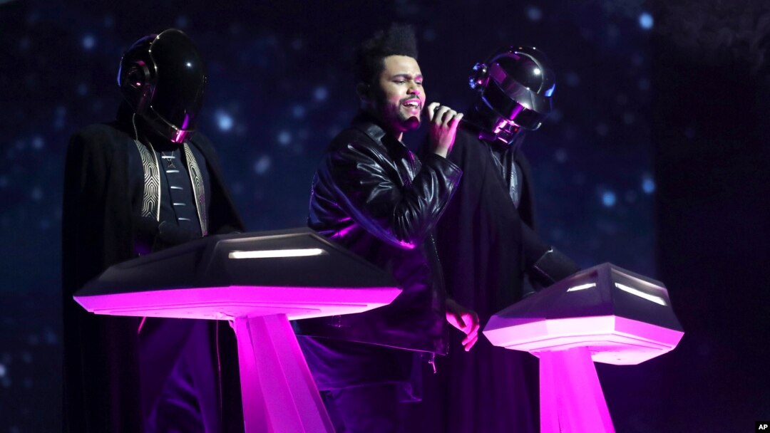 The Weeknd, center, and Daft Punk perform at the 59th annual Grammy Awards, Feb. 12, 2017.