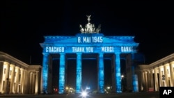 Germany's landmark the Brandenburg Gate is illuminated to mark the 75th anniversary of Victory Day and the end of World War II in Europe, in Berlin, Germany, May 8, 2020. 