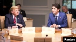 Canada's Prime Minister Justin Trudeau (R) and U.S. President Donald Trump participate in the working session at the G7 Summit in the Charlevoix town of La Malbaie, Quebec, Canada, June 8, 2018. 