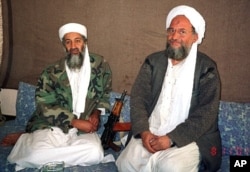 Osama bin Laden (L) sits with al-Qaida's top strategist and second-in-command Ayman al-Zawahri in this 2001 file photo