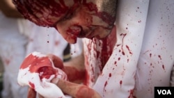 Often done with a knife stroke to the head, the act of bloodletting is called tatbir. (J. Owens/VOA)