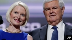 FILE - Former Speaker of the House Newt Gingrich, right, and his wife Callista test the speaking setup before the third day session of the Republican National Convention, July 20, 2016, in Cleveland. 