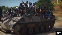 Screengrab from a Boko Haram video shows Boko Haram fighters parading on a tank in an unidentified town. Boko Haram has seized the town of Chibok in Borno state, northeast Nigeria, from where 276 schoolgirls were kidnapped, Nov. 9, 2014.