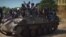Screengrab from a Boko Haram video shows Boko Haram fighters parading on a tank in an unidentified town. Boko Haram has seized the town of Chibok in Borno state, northeast Nigeria, from where 276 schoolgirls were kidnapped, Nov. 9, 2014.