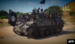 FILE - Screengrab from a Boko Haram video shows Boko Haram fighters parading on a tank in an unidentified town.