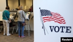 FILE - Voters cast ballots as early absentee voting began ahead of the U.S. presidential election in Medina, Cleveland, Ohio, U.S. Oct. 12, 2016.