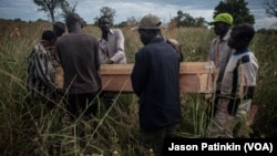 Pallbearers at the border of South Sudan and Uganda carry the casket containing the remains of Duku Evans, a civilian killed November 3 amid fighting between government troops and rebels in Logo displaced persons camp in Kajo Keji, South Sudan, Nov. 5, 20