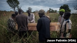 Pallbearers at the border of South Sudan and Uganda carry the casket containing the remains of Duku Evans, a civilian killed November 3 amid fighting between government troops and rebels in Logo displaced persons camp in Kajo Keji, South Sudan, Nov. 5, 2017.